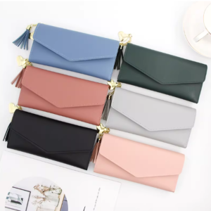 ladies long wallet with gold heart tassel zipper and snap button closure.