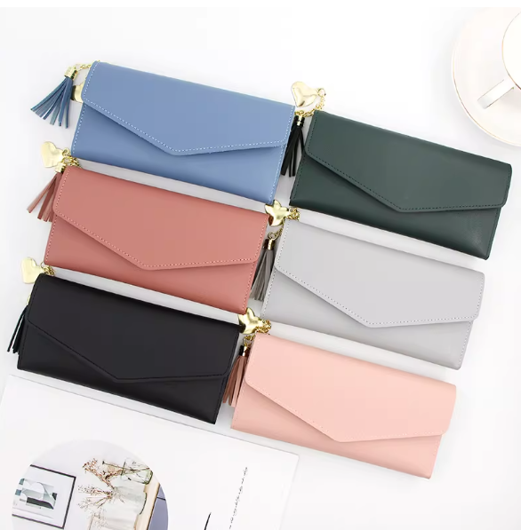 ladies long wallet with gold heart tassel zipper and snap button closure.