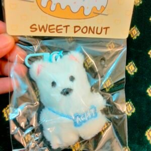 A collection of colorful, assorted mini plush keychain charms arranged neatly, individually packaged.