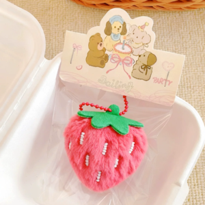 A collection of colorful, assorted mini plush keychain charms arranged neatly, individually packaged.