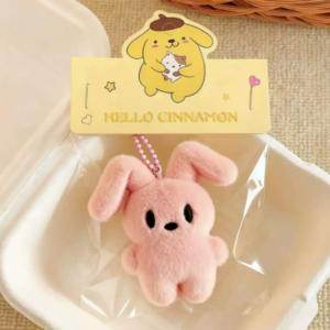 A collection of colorful, assorted mini plush keychain charms arranged neatly, individually packaged.