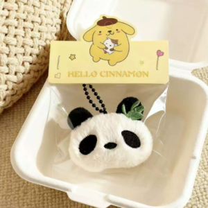 A collection of colorful, assorted mini plush keychain charms arranged neatly, individually packaged.