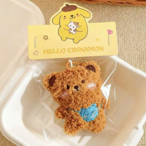 A collection of colorful, assorted mini plush keychain charms arranged neatly, individually packaged.