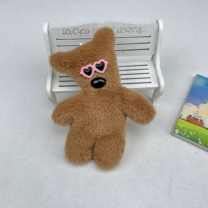 A collection of classic brown plush teddy bear keychains in various quirky styles attached to a bag.