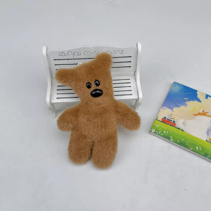 A collection of classic brown plush teddy bear keychains in various quirky styles attached to a bag.