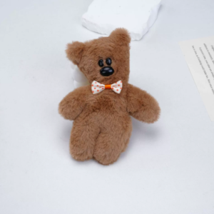 A collection of classic brown plush teddy bear keychains in various quirky styles attached to a bag.
