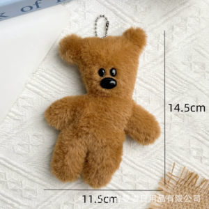 A collection of classic brown plush teddy bear keychains in various quirky styles attached to a bag.