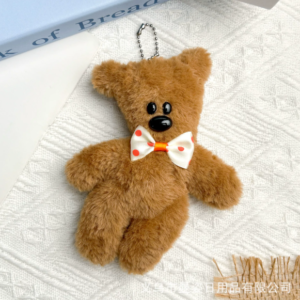 A collection of classic brown plush teddy bear keychains in various quirky styles attached to a bag.